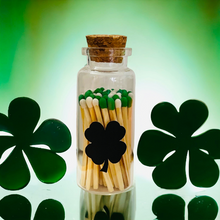 Load image into Gallery viewer, Saint Patrick&#39;s Day Colored Tip Matches in glass jar with cork top, shamrock decor, With 4 leaf clover shaped match striker on front of Vial
