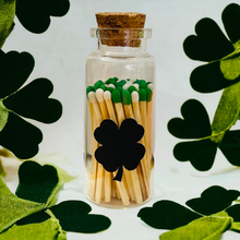 Load image into Gallery viewer, Saint Patrick&#39;s Day Colored Tip Matches in glass jar with cork top, shamrock decor, With 4 leaf clover shaped match striker on front of Vial
